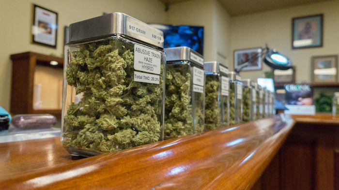 Jars of loose bud are shown in an unlicensed dispensary. 